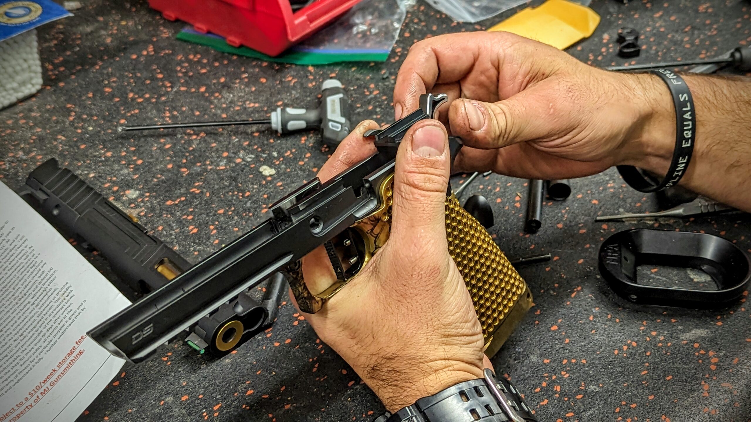 Eli's hands working on a Springfield Prodigy to demonstrate gunsmithing service lead times.